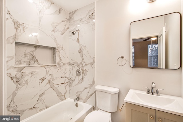 full bathroom with vanity, ceiling fan, toilet, and tiled shower / bath