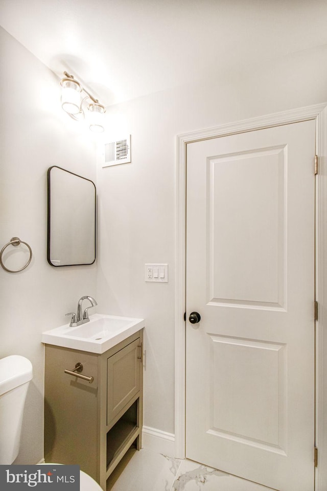 bathroom with vanity and toilet