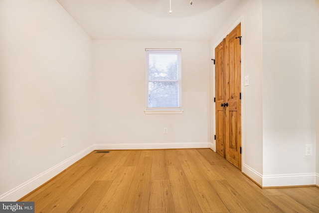 unfurnished room with light hardwood / wood-style floors