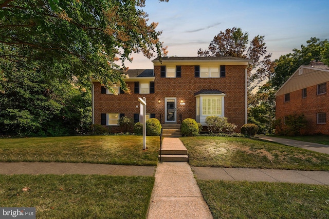 view of front of property with a lawn