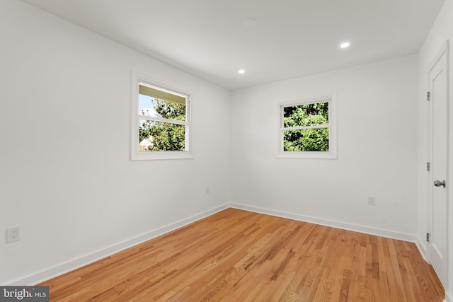 unfurnished room featuring light hardwood / wood-style floors and a wealth of natural light