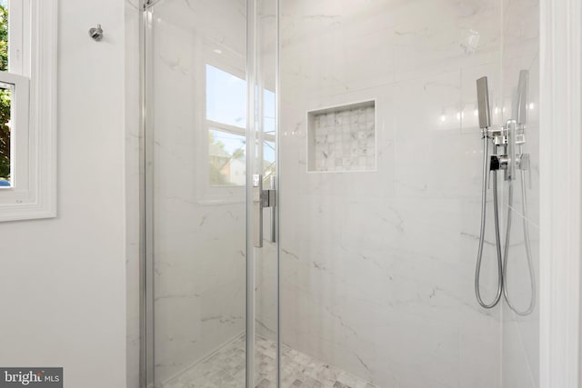 bathroom with a shower with door