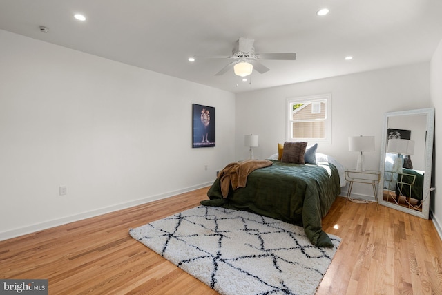 bedroom with ceiling fan and light hardwood / wood-style floors