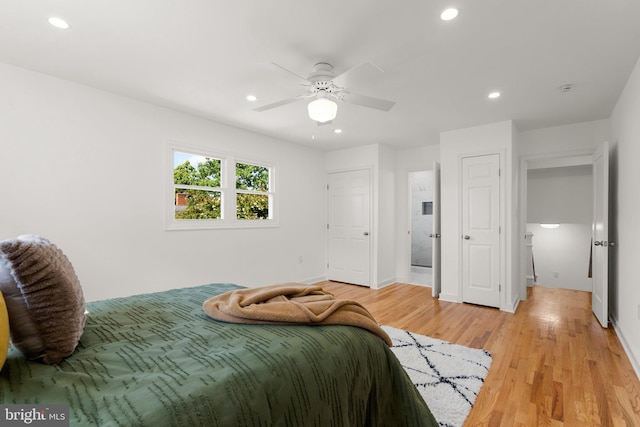 bedroom with ceiling fan and light wood-type flooring