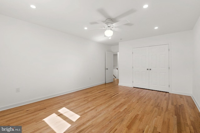 unfurnished bedroom with ceiling fan, light hardwood / wood-style floors, and a closet