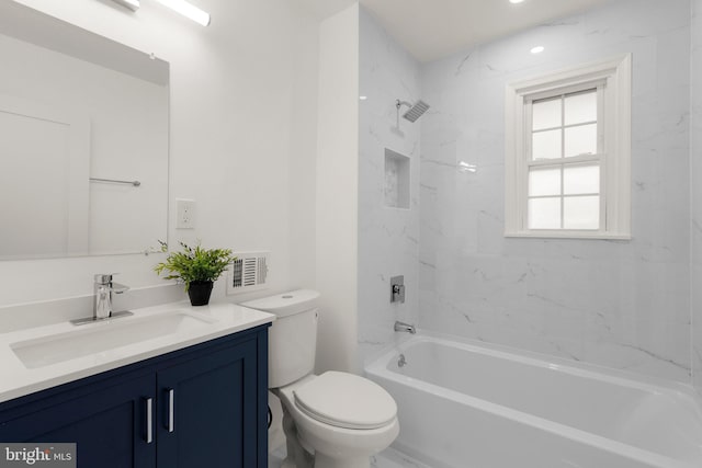 full bathroom featuring vanity, tiled shower / bath combo, toilet, and a wealth of natural light