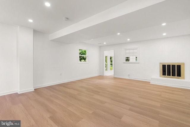 unfurnished living room with light wood-type flooring and a fireplace