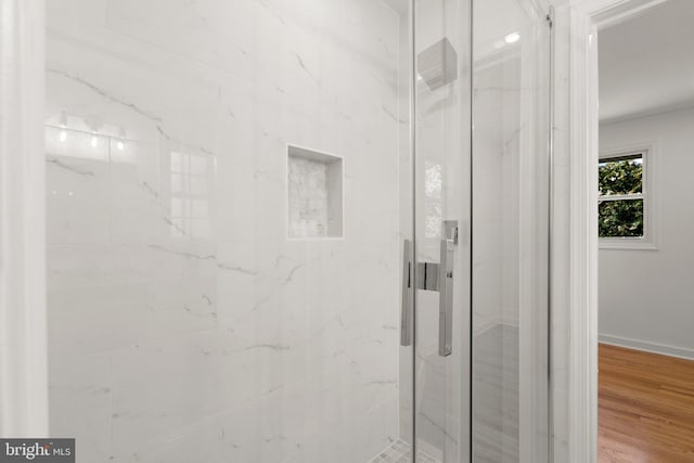 bathroom featuring wood-type flooring and walk in shower