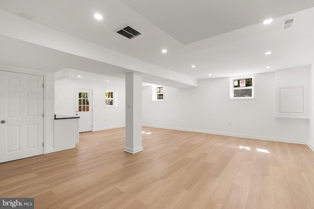 basement with light hardwood / wood-style floors