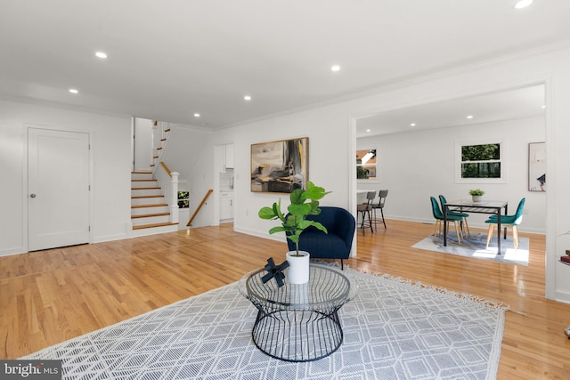 living room with hardwood / wood-style flooring and ornamental molding