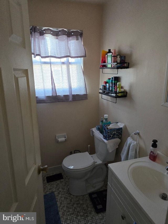 bathroom with tile patterned floors, vanity, and toilet