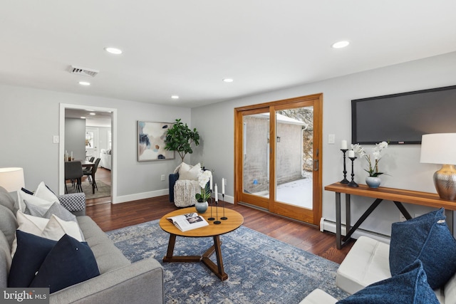 living room with dark hardwood / wood-style flooring and a baseboard radiator