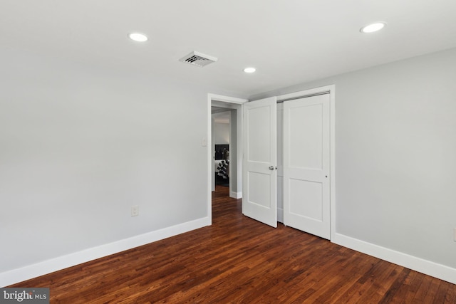 unfurnished bedroom featuring dark wood-type flooring