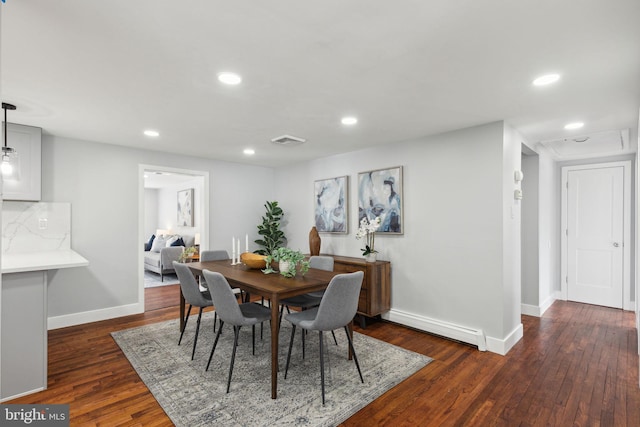 dining room with dark wood-type flooring and a baseboard radiator