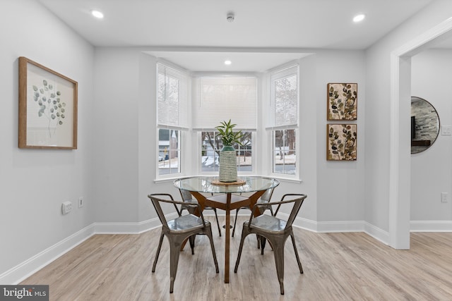 dining room with light wood-type flooring and plenty of natural light