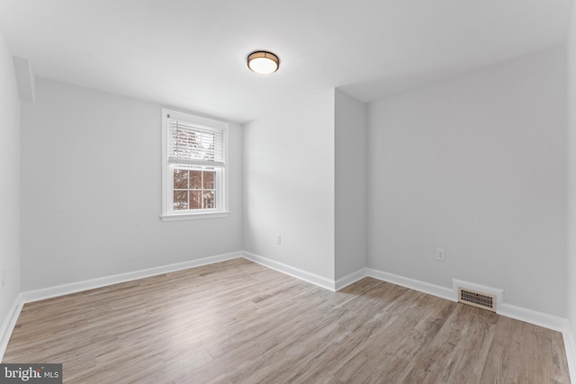 spare room featuring light hardwood / wood-style floors