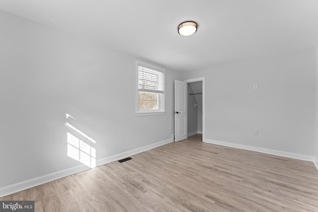 spare room with light hardwood / wood-style flooring