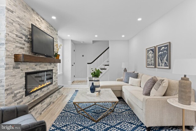 living room with hardwood / wood-style floors and a fireplace