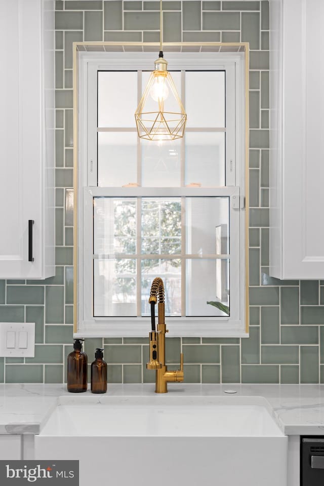 details with dishwashing machine, decorative backsplash, and sink