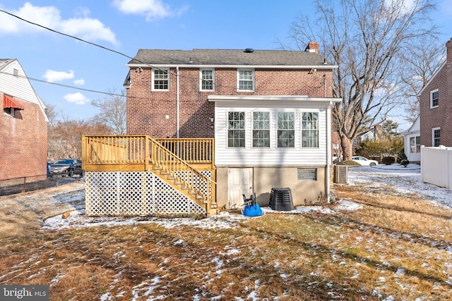 snow covered property featuring a deck