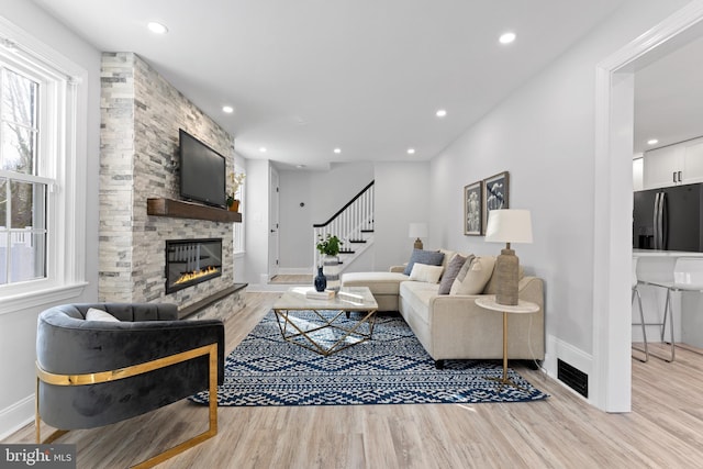 living room featuring a fireplace and light hardwood / wood-style floors