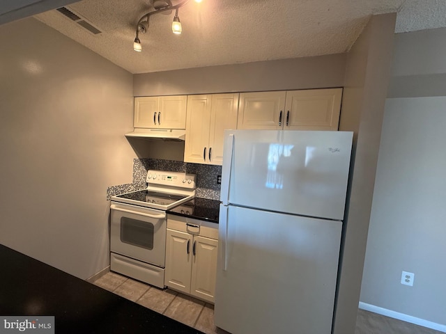 kitchen featuring rail lighting, tasteful backsplash, white appliances, white cabinetry, and light tile patterned flooring