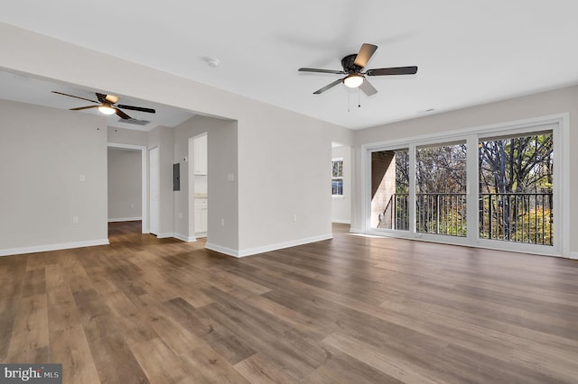 unfurnished living room with electric panel, ceiling fan, and wood-type flooring