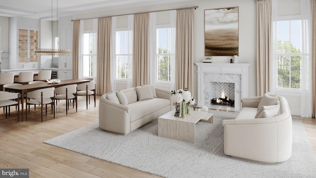 living room featuring a fireplace, wood-type flooring, and crown molding