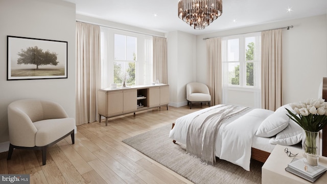 bedroom featuring light wood-type flooring, an inviting chandelier, and multiple windows