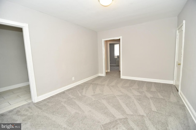 unfurnished bedroom featuring light carpet