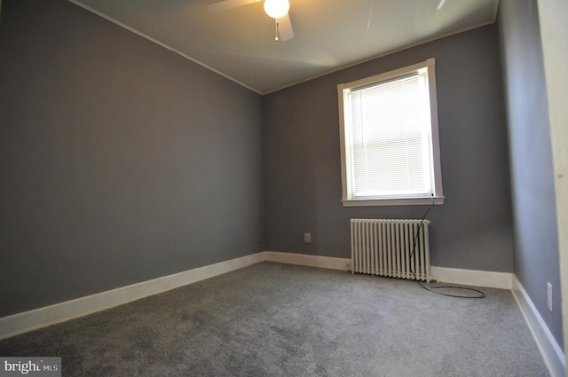 carpeted spare room with radiator and ceiling fan