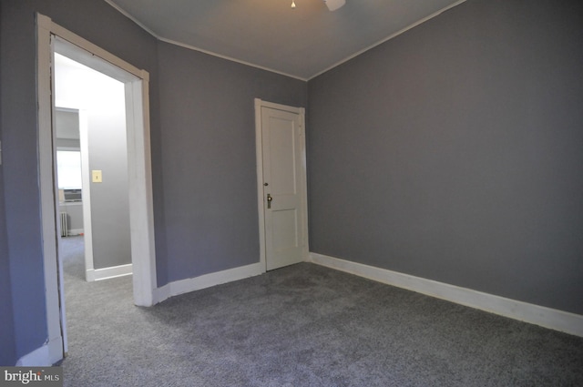 unfurnished room with crown molding and carpet floors