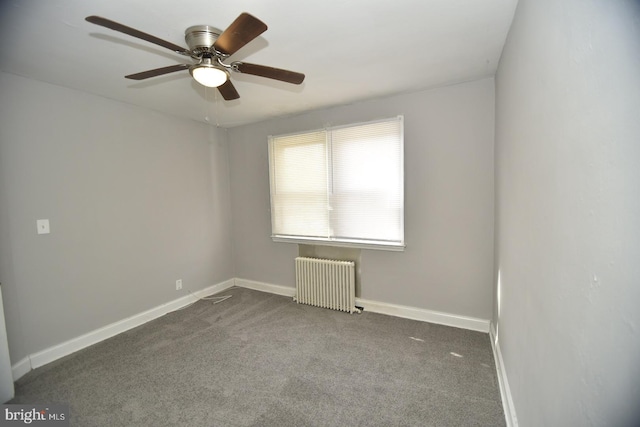 carpeted empty room with radiator and ceiling fan