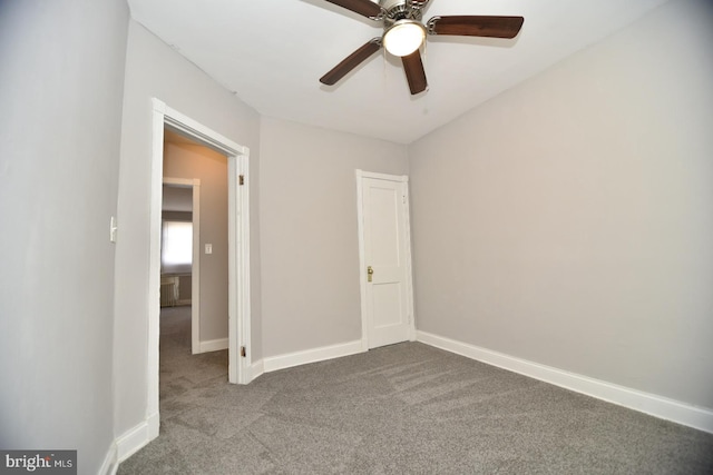 empty room featuring carpet flooring and ceiling fan