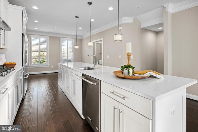 kitchen featuring pendant lighting, sink, white cabinets, a kitchen island with sink, and stainless steel appliances