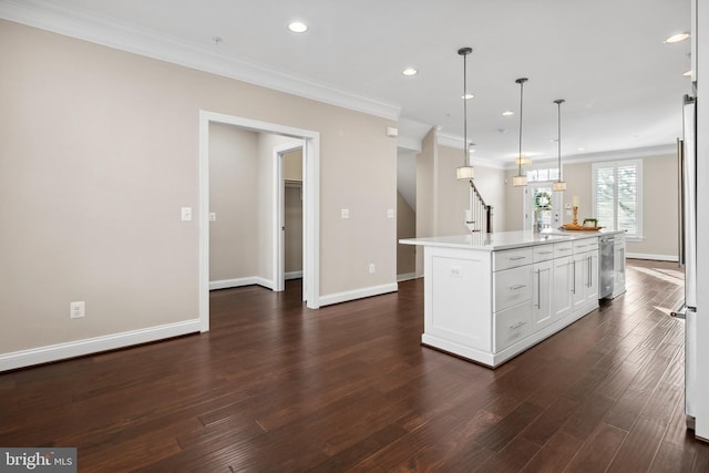 kitchen with white cabinetry, stainless steel dishwasher, ornamental molding, an island with sink, and pendant lighting