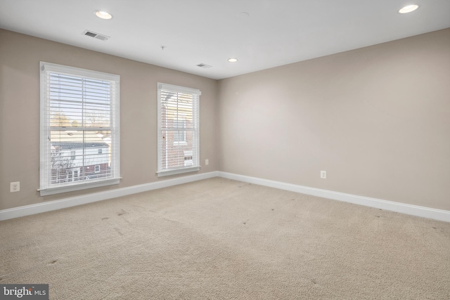 empty room featuring light colored carpet