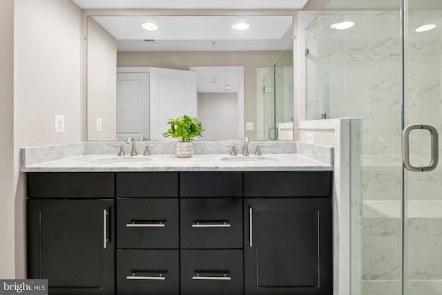 bathroom with vanity and a shower with door