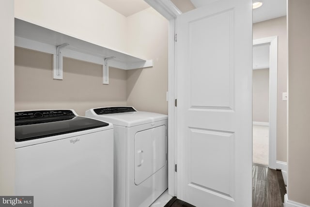 laundry room with dark wood-type flooring and washer and clothes dryer