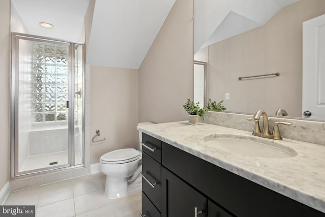 bathroom with tile patterned floors, toilet, vaulted ceiling, vanity, and a shower with door