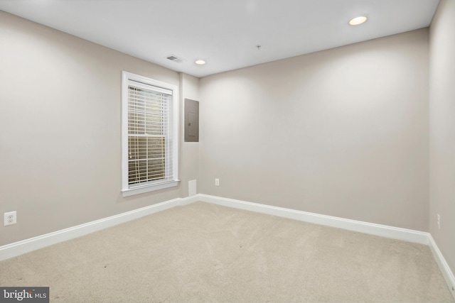 empty room with light carpet and electric panel