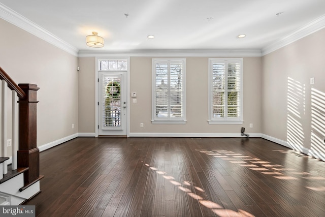 foyer entrance with ornamental molding and dark hardwood / wood-style floors