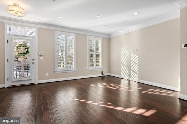 empty room featuring ornamental molding and dark hardwood / wood-style floors