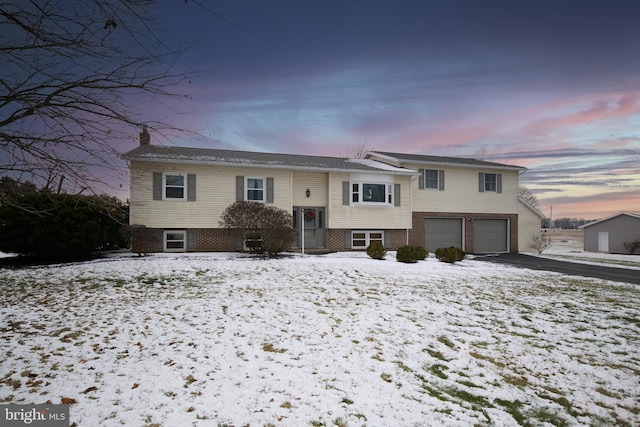 214 Ringneck Dr, Bellefonte, PA 16823 - raised ranch with aphalt driveway, brick siding, a garage, and a chimney