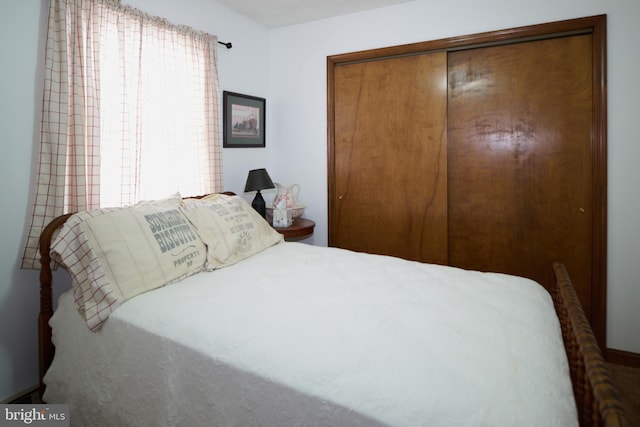 bedroom with multiple windows and a closet