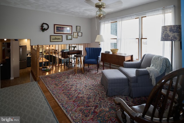 living room with ceiling fan and a textured ceiling