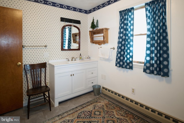 bathroom with tile patterned floors, vanity, and a baseboard heating unit