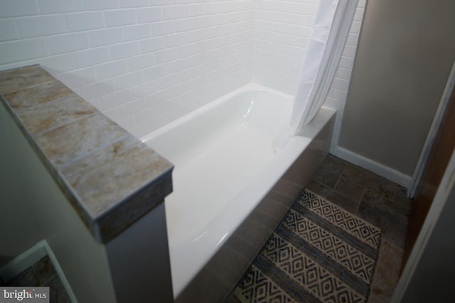 bathroom featuring tile patterned floors and shower / bath combo