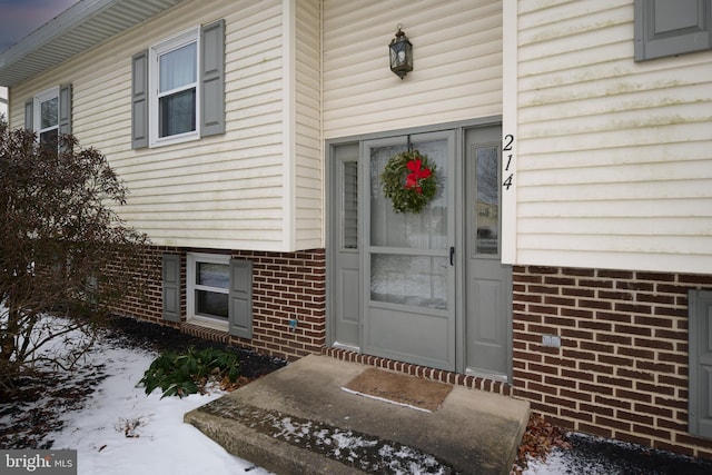 view of snow covered property entrance