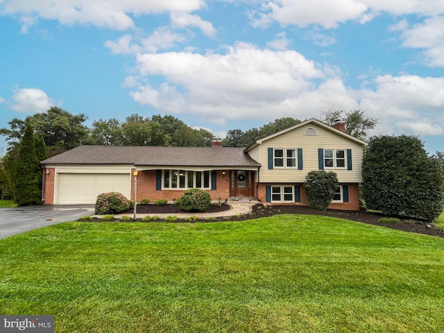 tri-level home with a front yard and a garage